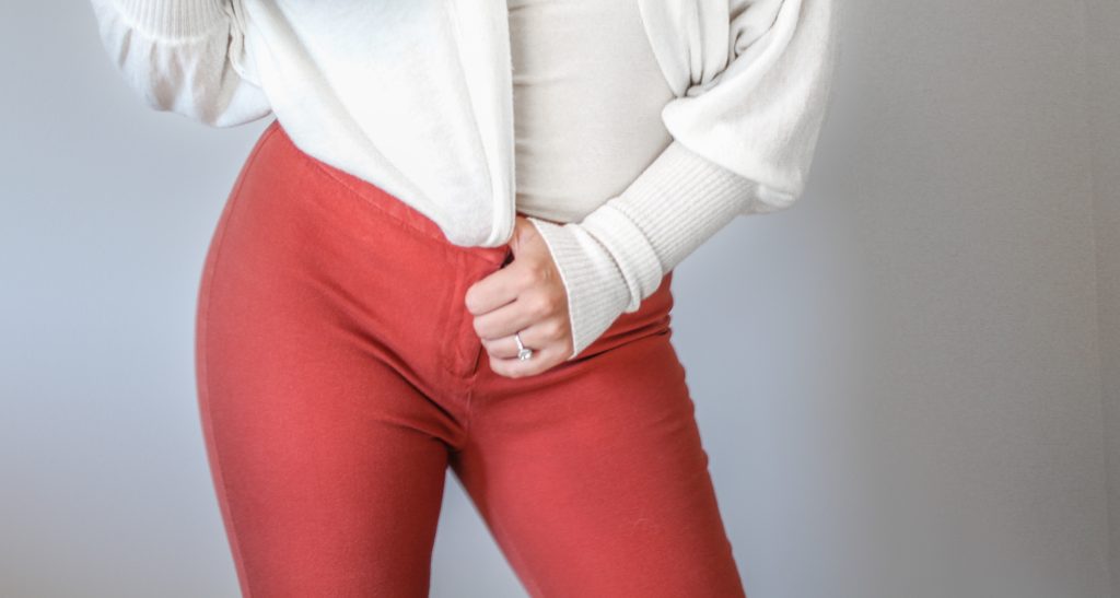 coral pants and white sweater