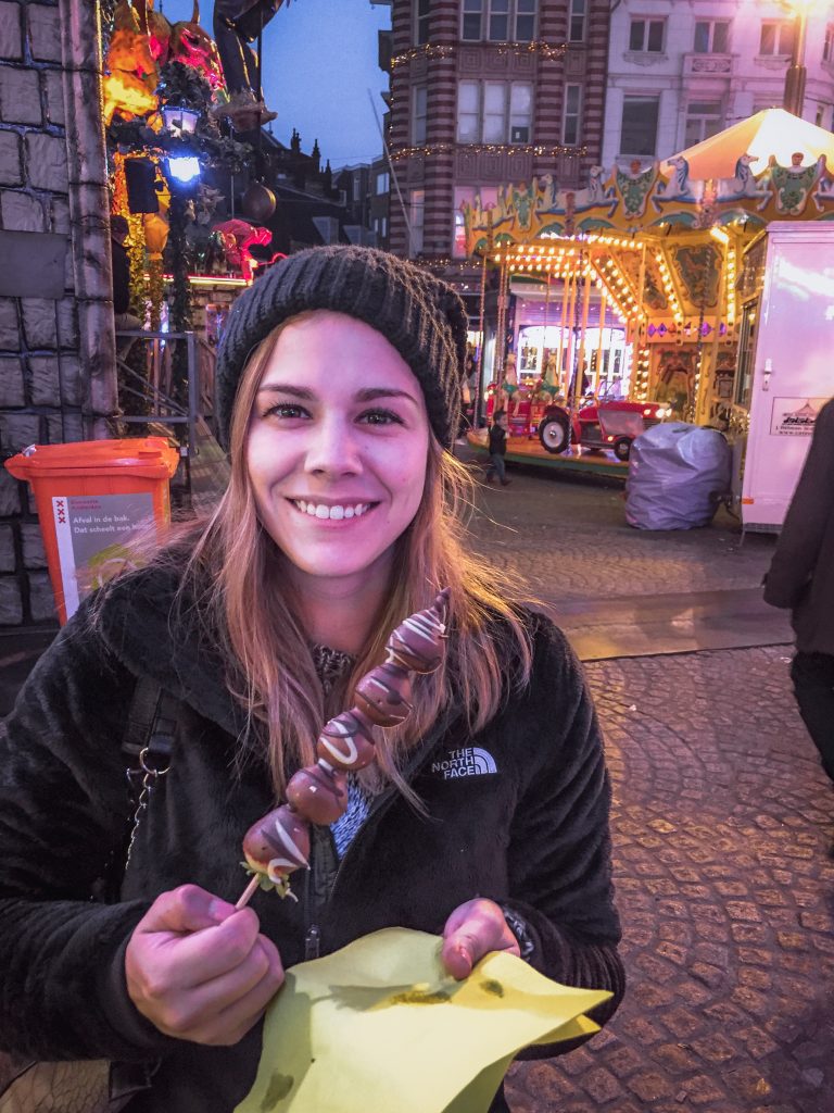 eating chocolate covered strawberries in amsterdam carnival