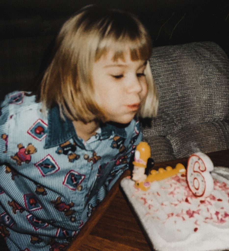 me blowing out my candles at age 6