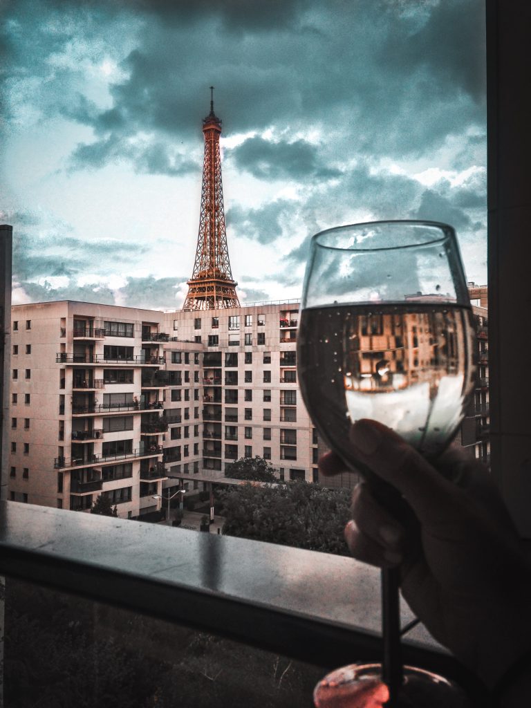 Me drinking wine from our balcony in Paris, toasting the Eiffel Tower