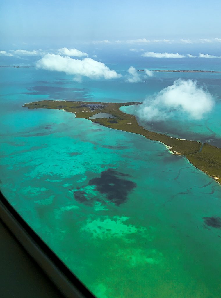 Flying over the islands with the teal water