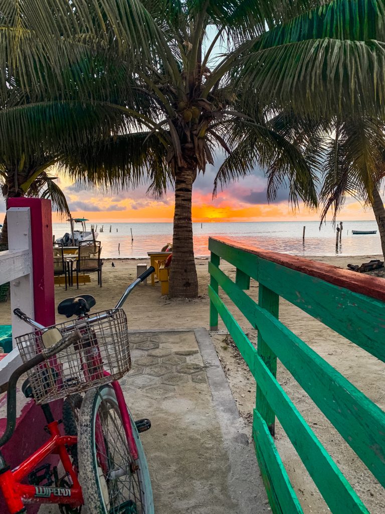 Steps leading out to the beach with the sunrise in Caye Caulker