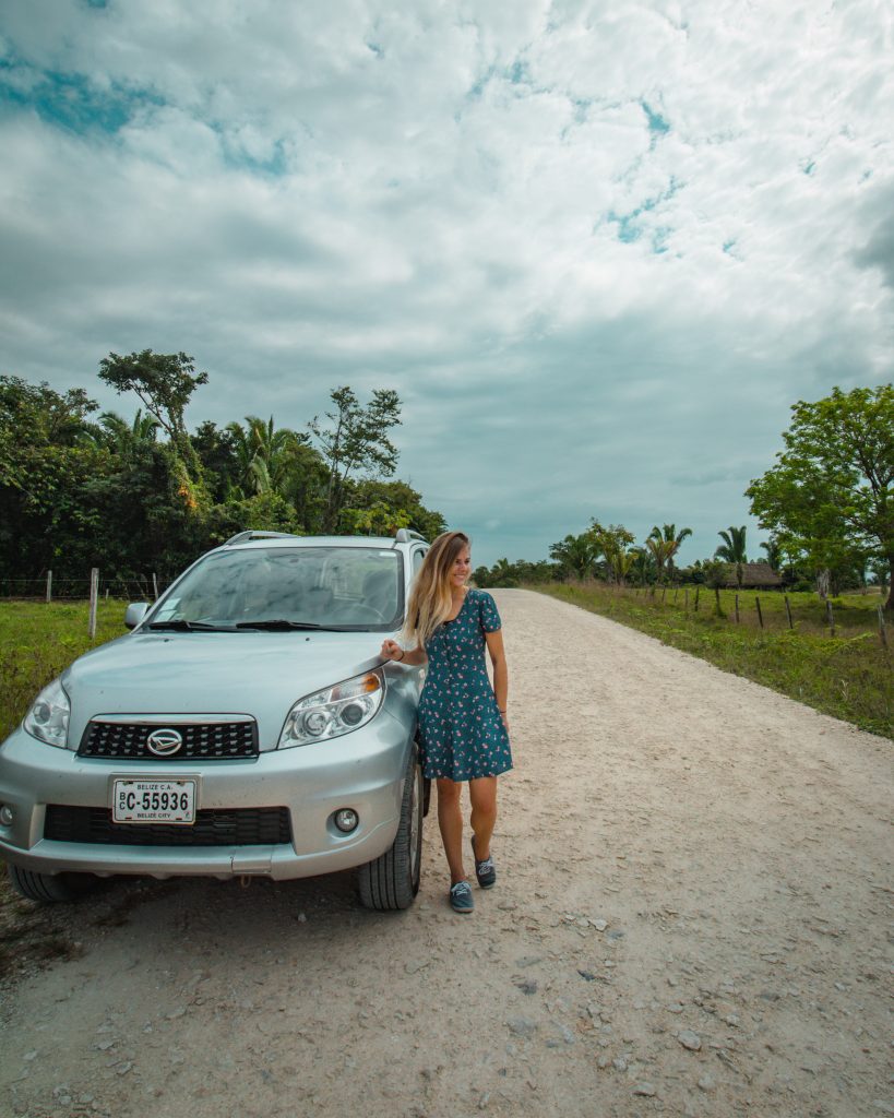 Me with our rental car out in the middle of Belize