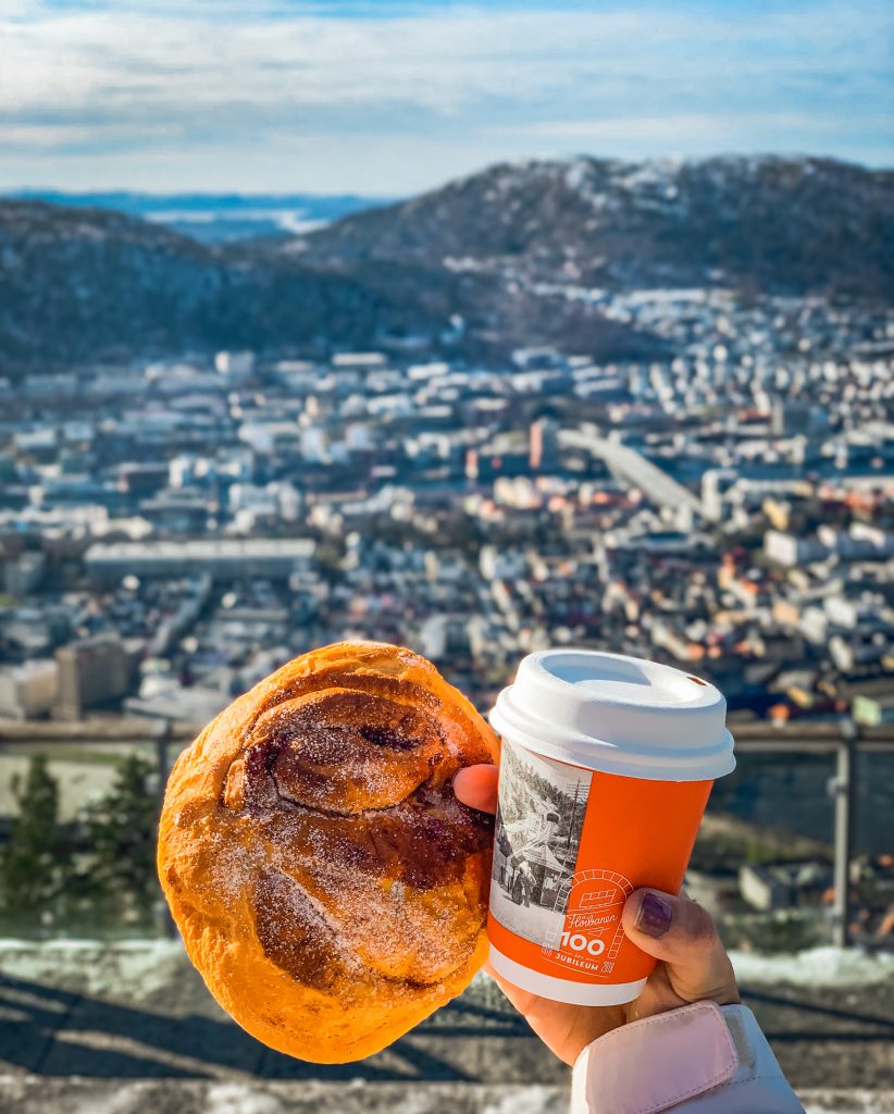 Cinnamon bun and cappuccino with views of Bergen