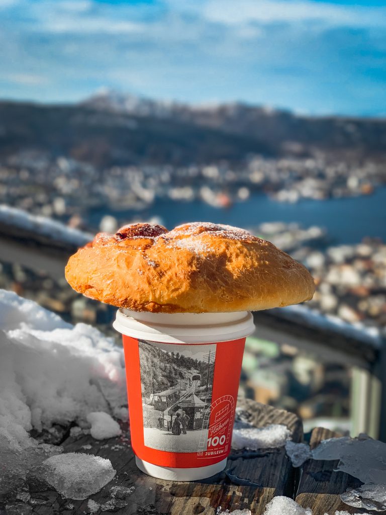 Cinnamon bun and cappuccino with aerial views of Bergen