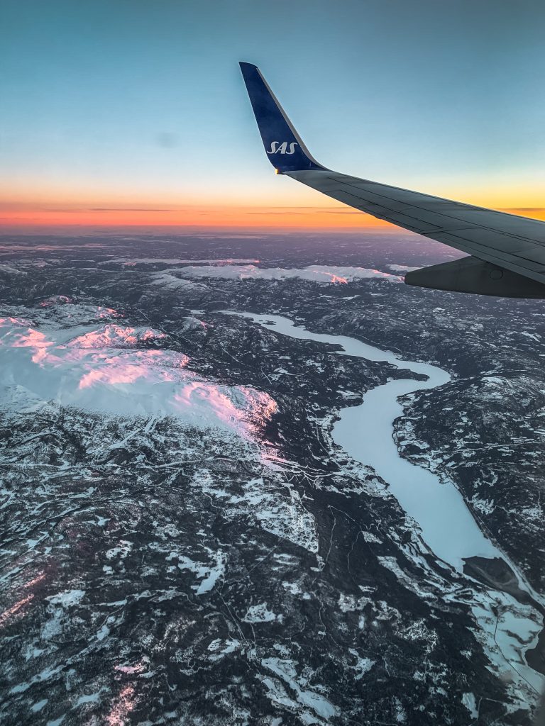 Flying over the frozen fjords at sunrise in Norway