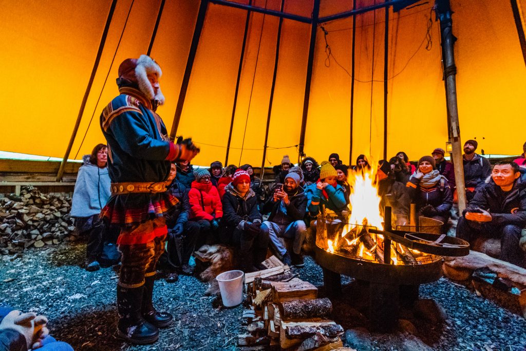 Sami talking over a campsfire in a Lavvu
