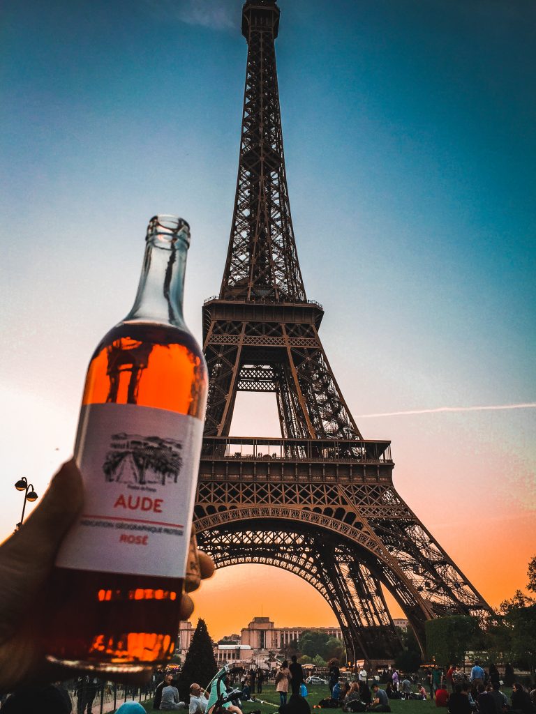 Bottle of wine and the Eiffel Tower at sunset