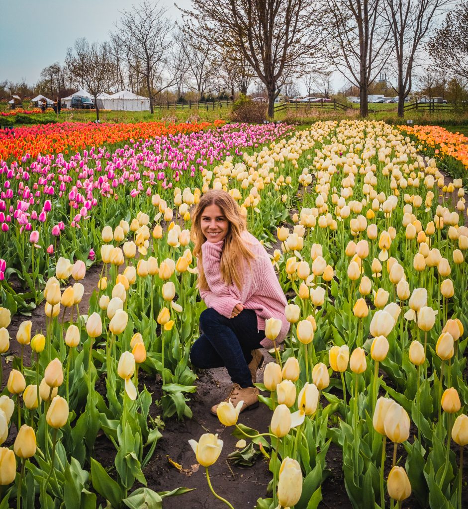 Me among a ton of tulips in a garden