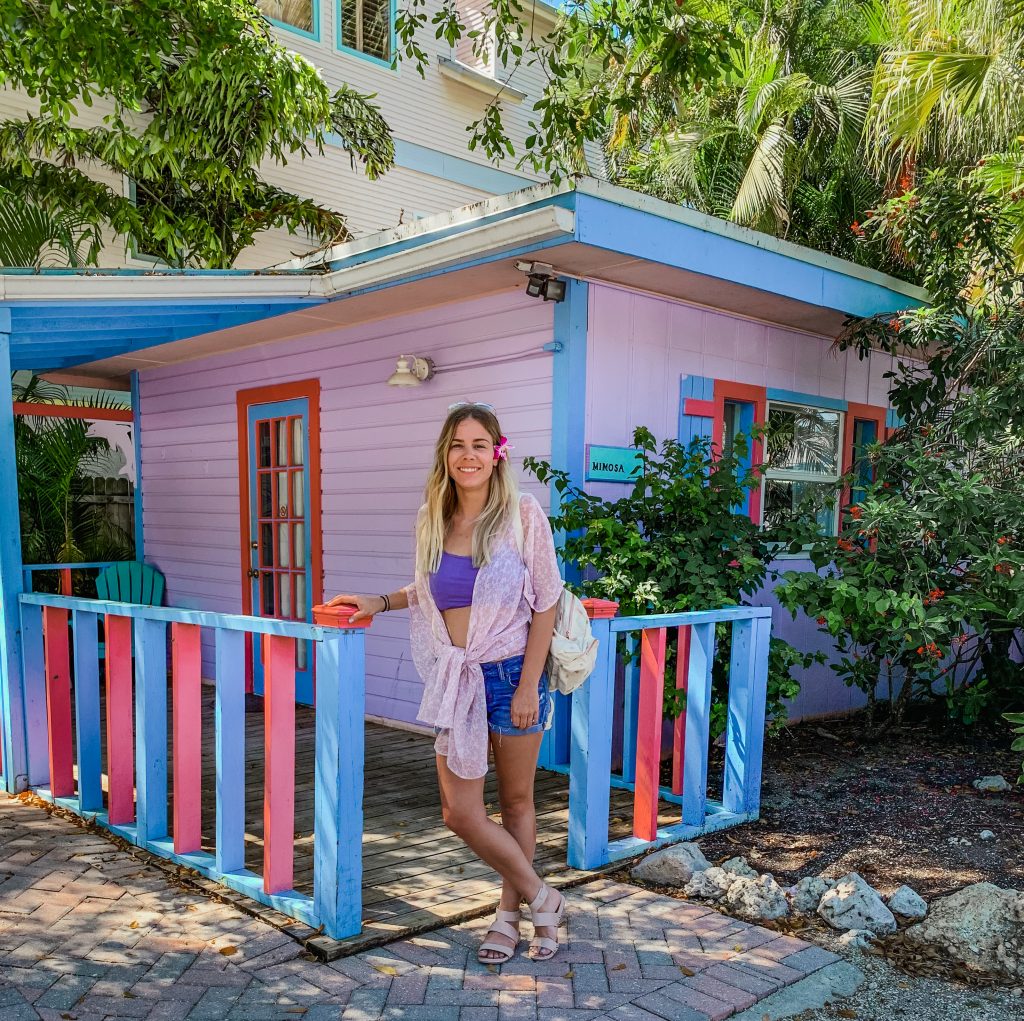Me in front of a colorful beach cottage