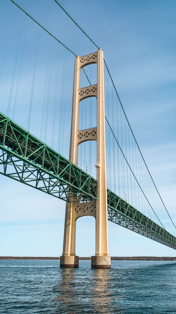 Photo from the water looking up at the Mackinac Bridge