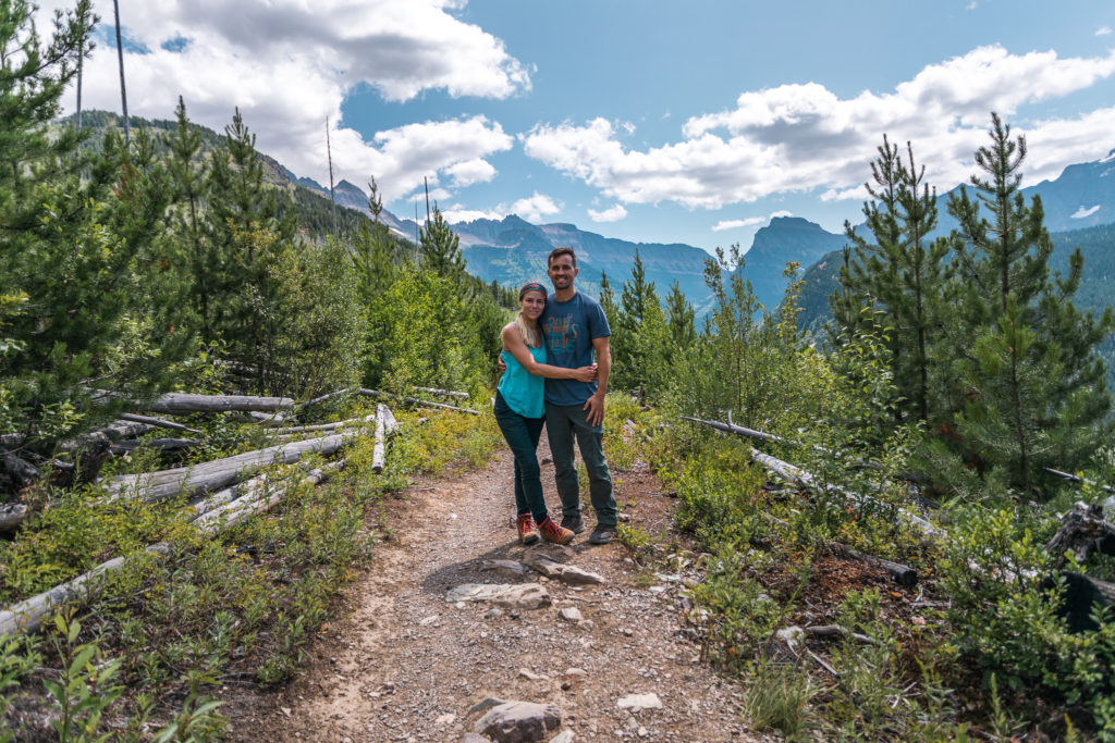 couple hiking highline trail in glacier national park